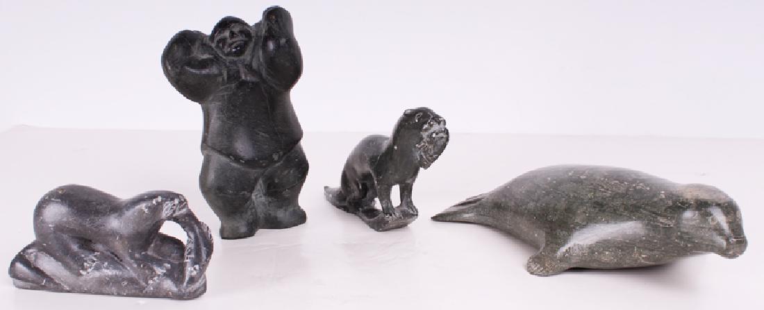 Inuit Artists (20th Century) (four): SEALS WITH FISH (2); SEAL; MAN CARRYING PACK, four carved soapstone sculptures, Seals With Fish both signed and inscribed and with Canadian Eskimo Art labels underneath, Man numbered and signed in Esk