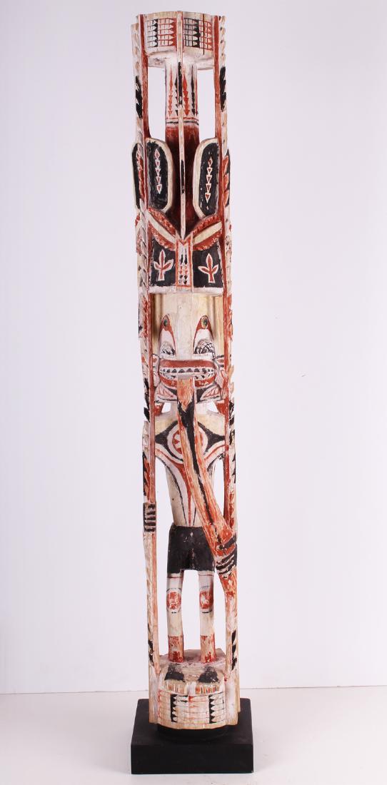 Oceanic Totemic Ancestral Statue: MALE FIGURE WITH HEADDRESS, elaborately carved wood statue with clay and pigment, 48 x 8 x 8” with metal stand. From the collection of Selma & Herbert Moskowitz.