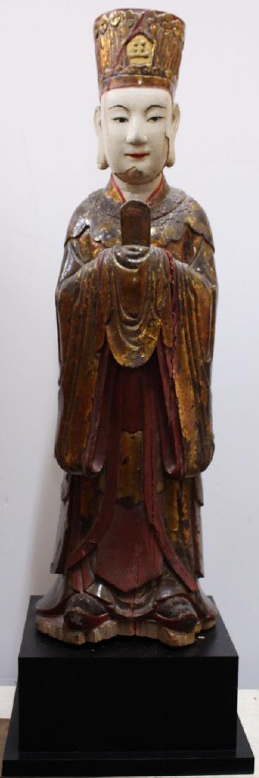Asian Decorative Art: Chinese Statue: SCHOLAR HOLDING TABLET, painted wood sculpture, 36” tall, overall 43 ¼ x 14 x 13” with wood stand. From the private collection of Academy Award winning producer Arnold Kopelson of Beverly Hills.
