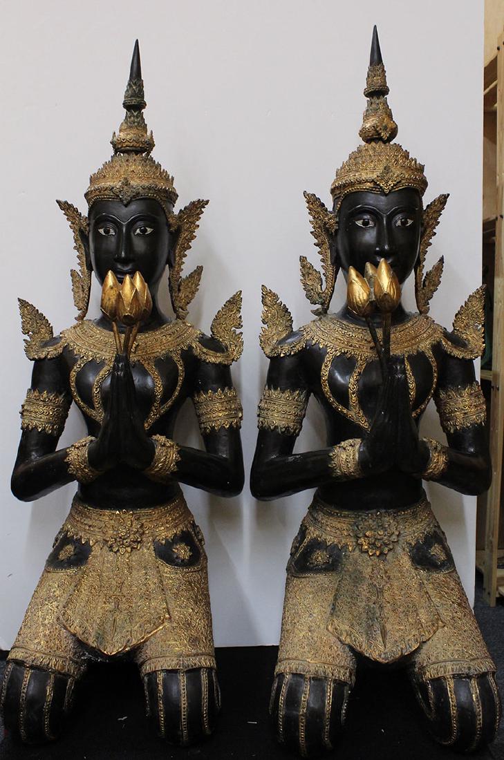 Asian Decorative Art: Thai Statuary (two): THEPPHAANOM, two kneeling attendants, each a metal statue painted black and gold with removable nobs, each 46 x 17 x 17”. From the private collection of Academy Award winning producer Arnold Kopelso