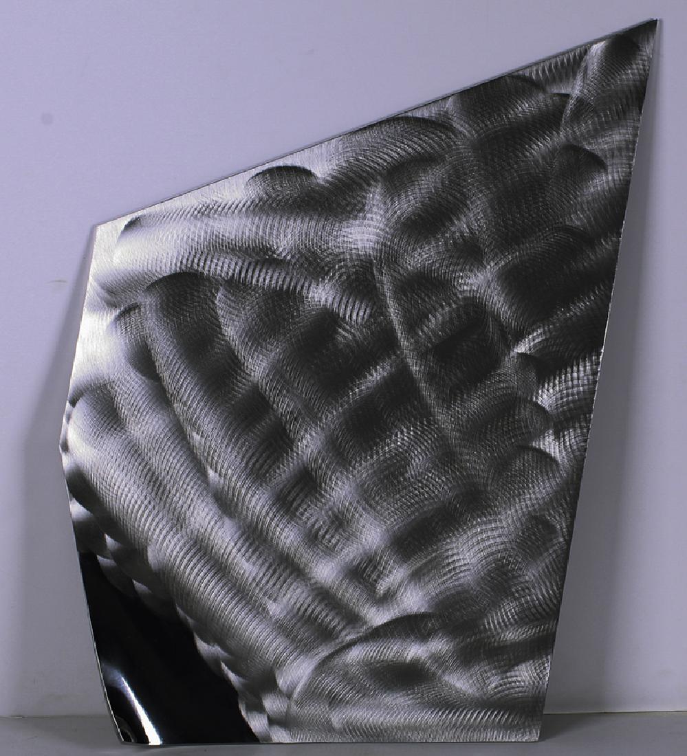 Ellie Riley (20th Century) California: WIND PILLOW,1998, steel wall sculpture with brushed finish and high polish, signed and dated and titled and inscribed 1/19 M-98-036 in marker on verso, 23 ½ x 29 ¼ x 1 ½”.
