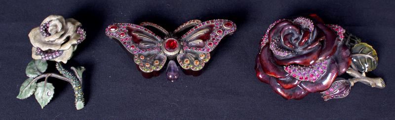 Decorative Arts: Jay Strongwater design (three): FLOWERS & BUTTERFLY, three enamel and decorated metal boxes, each hallmarked, from 5” to 3 ½” lengths. (3)