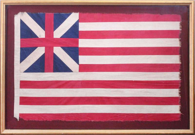 Americana: The Grand Union Flag: Stitched cloth flag reproduction with simulated aging approximately 25 x 39”, frame 31 ¼ x 35 ½”. Provenance: Gallery of the Republic stamp of back of frame.
