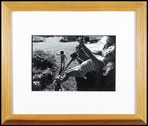 Marcus Kenney (b. 1972) American: SWINGING, silver gelatin print, image 10 ½ x 15 ¾", full margins, framed with glass.