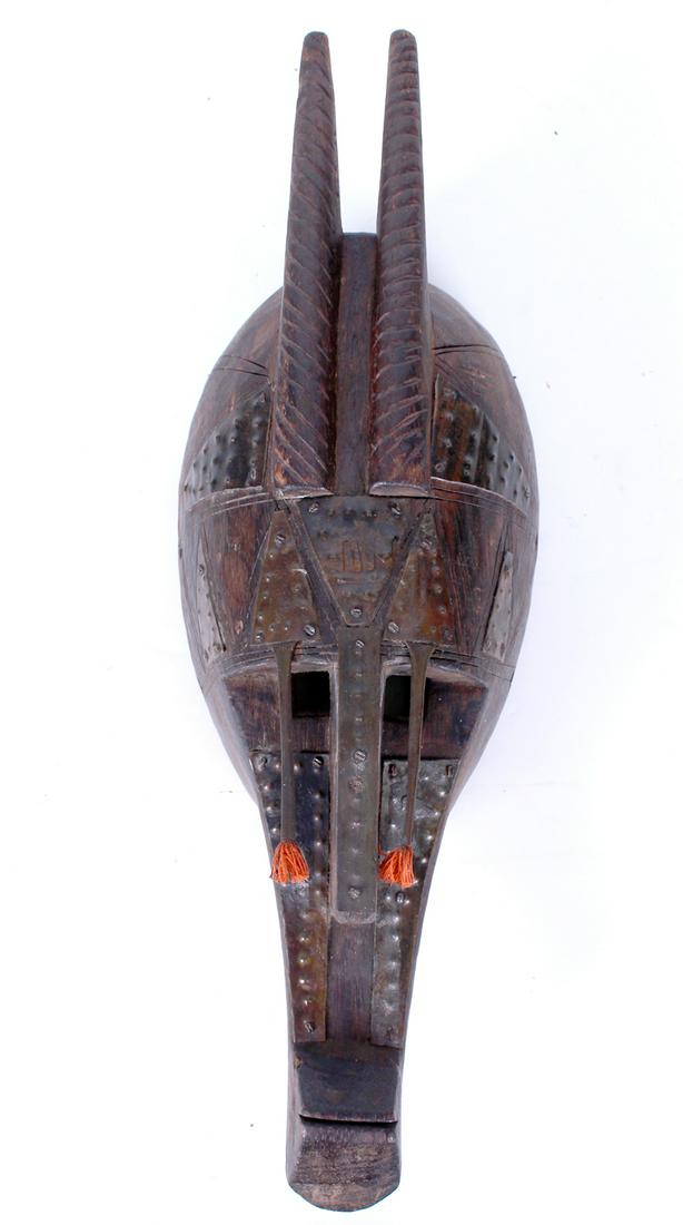 Bambara Mali African Art: MARKA MASK, carved wood with metal overlay and yarn plumes, 18 x 6 x 4”. From the collection of a Beverly Hills Art Historian and Museum donor. Provenance: Patti African Art, West Hollywood.