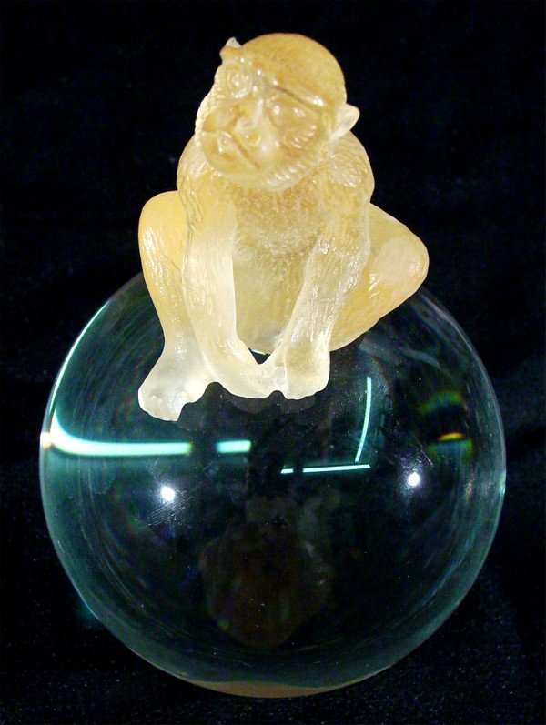 Daum glass: MONKEY ON TOP OF THE BALL, yellow etched glass atop clear polished glass, signed, 7" tall, faint surface scratches, otherwise in good condition.