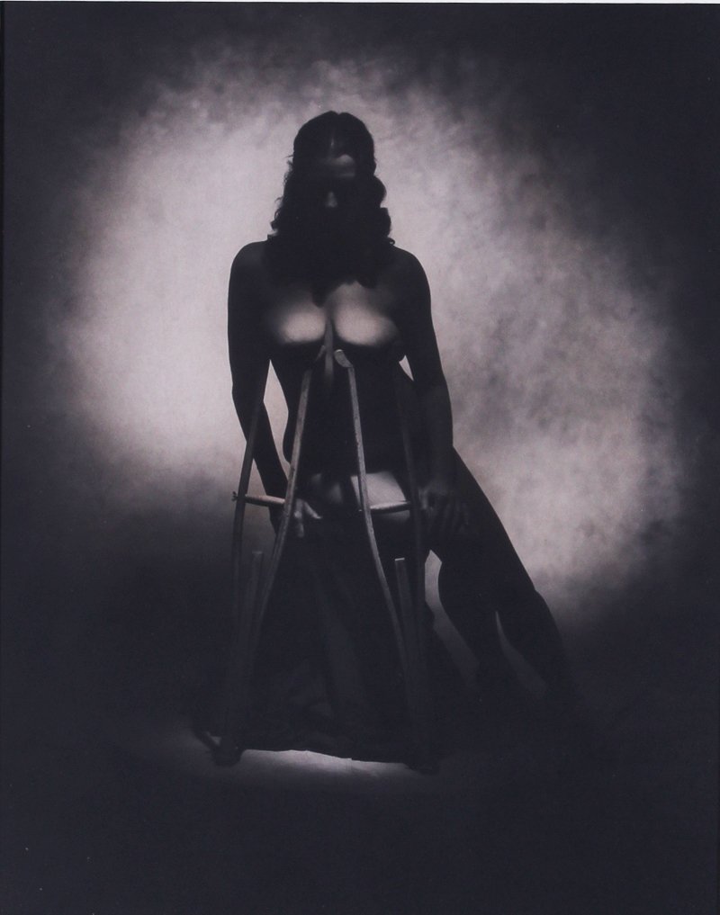 Rocky Schenck (b. 1955) Texas: NUDE WITH CRUTCHES, 1983, gelatin silver print, signed and dated and titled on verso, 14 x 11”. From the collection of Laurie Frank, Frank Picture Gallery Santa Monica.