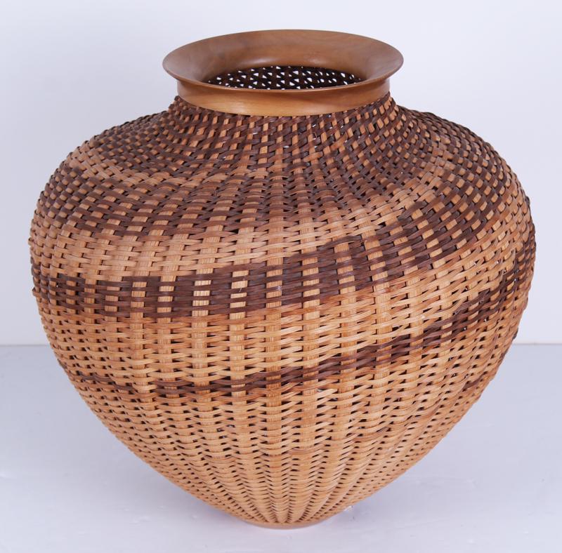 Folk Art: Connie McColley & Tom McColley: Hand woven hickory wood basket with swirl design and turned wood rim and base, signed and dated 87-66 underneath, 15” tall & 15” diameter. Originally from the Ramona Lampell collection, wh