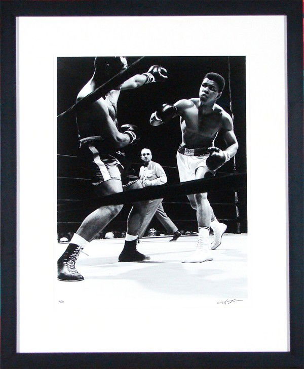 Neil Leifer (b. 1942) American: MOHAMED ALI VERSUS ZORA FOLEY, 1962, silver gelatin print, signed in ink, from a later numbered edition of 150, image 18 x 14", full margins, framed with glass.