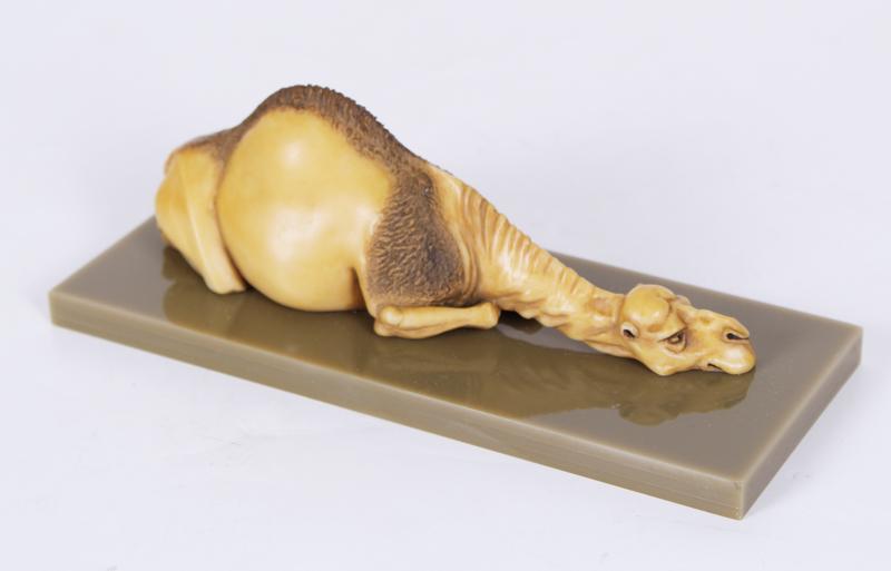 Sylvia Massey (20 th Century) California: CAMEL, hand-painted resin sculpture, signed and inscribed AP (artistâ€™s proof) from an unrealized edition, overall including Plexiglas box 3 ¼ x 7 x 3”.