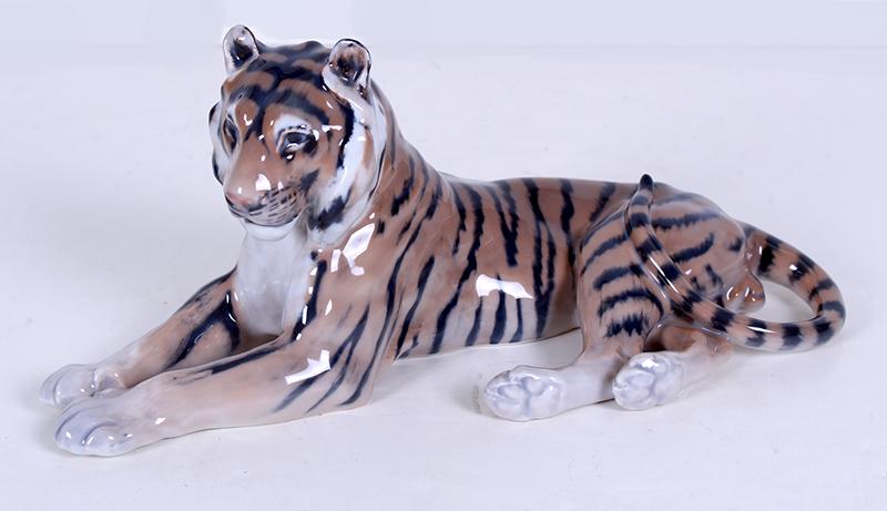 Royal Copenhagen (20 th Century): TIGER, painted and glazed porcelain figurine, hallmarked and inscribed 714 underneath, 5 ¼ x 12 ¼ x 5 ½”.