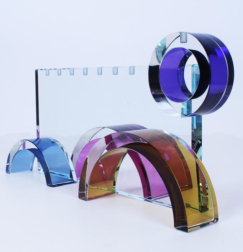 Fay Miller (20 th Century) American: MENORAH, clear and color glass menorah, a signature not found, 8 ½ x 17 x 4 ¾”.