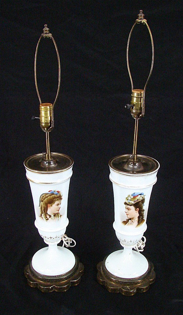 Decorative Arts: Victorian Lamps (two): A pair of white porcelain Victorian lamps with contra posing busts of women and gilt, with two-tiered metal bases, adjustable heights, each approximately 20:” tall, wired for electricity, portraits 