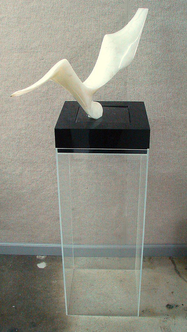 Leonardo Nierman (b. 1932) Mexican: FLIGHT, carved white onyx sculpture, signed, 16 ½ x 30” x 4”, black marble base encased in 3” swivel base, 36” Plexiglas box stand, overall height 55 ¾”.