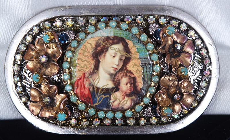 Shayna Saide La Beouf (1942-2022) New York California: MOTHER & CHILD, hand-made mixed media metal belt buckles, with collaged images, applique, rhinestones and faux or semi-precious stones, signed on back, size 2 ¼ x 4”, with 4 x 6 x 1 &frac