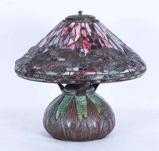 Style of Tiffany Studios New York (20th Century): DRAGONFLY LAMP, mosaic Arrowroot style base, Dragonfly style shade resting on tri-arm support, with triple lamp sockets, base and shade bears hallmarks, 16 &frac12;&rdquo; diameter, 16 &frac12;&rdquo;