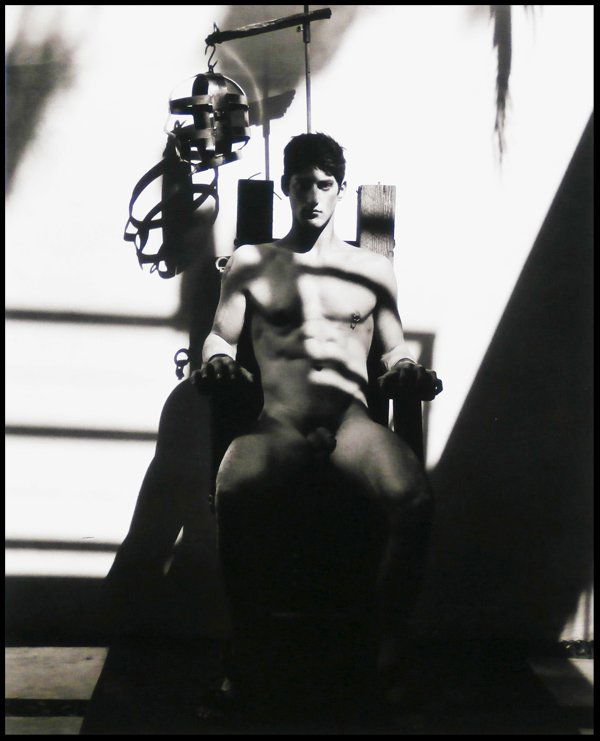 Greg Gorman (b. 1949) American: TONY IN ELECTRIC CHAIR, 1988, gelatin silver print on card, signed and dated and with the artist’s stamp on the verso, 24 x 19 ½”, from the numbered edition 15.