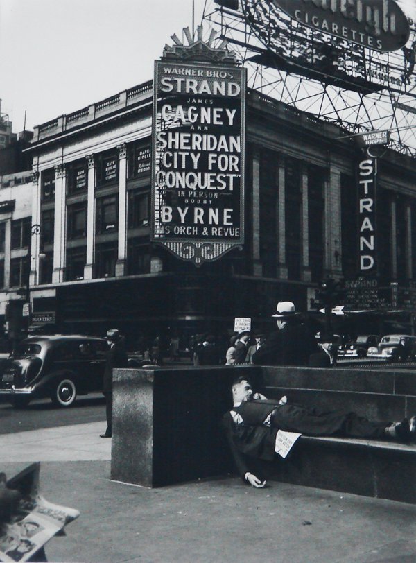 Lou Stoumen (1917-1991) American: THE STRAND, TIME SQUARE, 1940, gelatin silver print from a later edition c.1980, photographer’s stamp on verso, sight 11 ¾ x 9, matted, small particle residue in margins, otherwise in good conditio