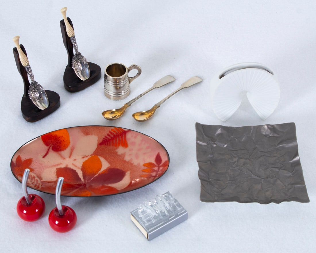 Decorative Objects: Metals & Porcelain: Two sterling silver spoons with wooden holders, spoons 4” long including carved handles; A 1 ½” commemorative engraved silver shot-glass; Two 4 ¾” long demi-tasse silve