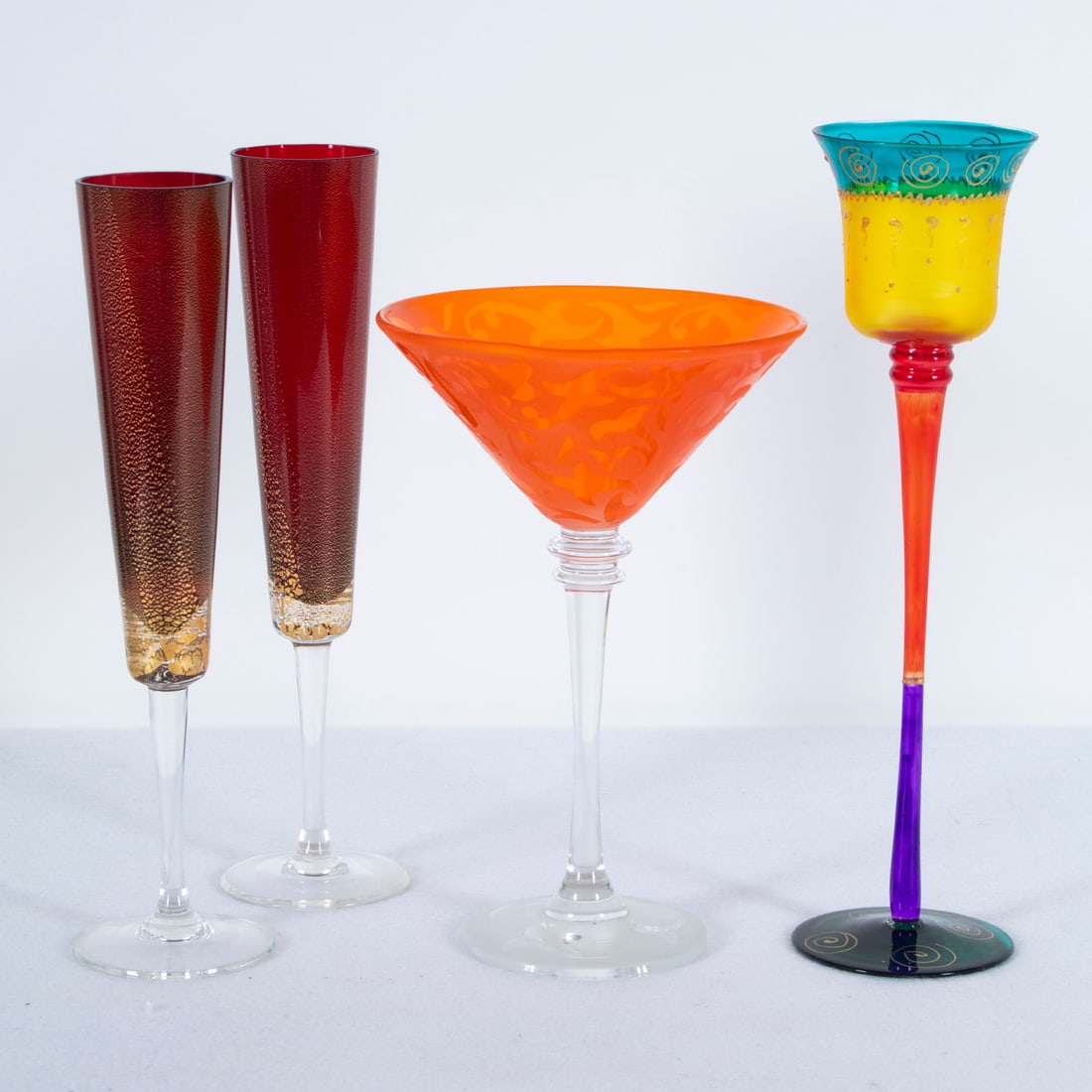 Otto Franek (20 th Century), Michael Weems & art glass (2): Two color glass mimosa or champagne flutes with gold flecks, each 10 ½” tall. Provenance: Del Mano Gallery, Los Angeles; Michael Weems Orange etched and frosted large color martini glass,