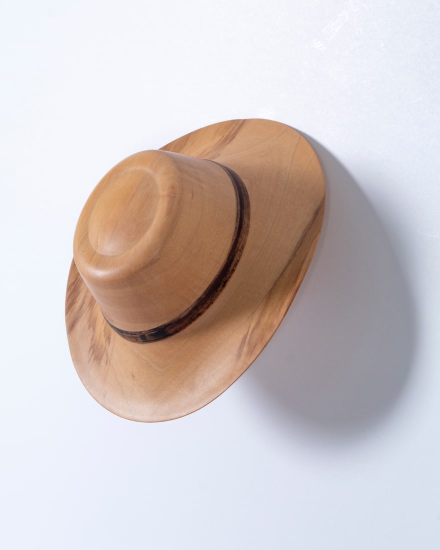 Johanne Michelsen (b. 1945) American: HAT, 1993, carved wood sculpture, signed and dated and inscribed #21 Spaufle Sugar Maple on interior, 2 ½ x 4 ¾ x 5 ¼”, with wooden wall peg.