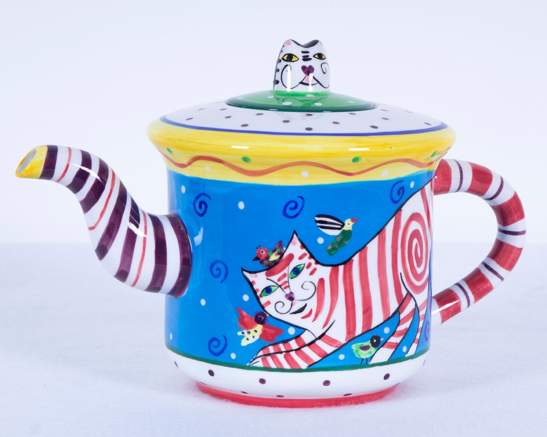 Dana Simson for Art Impressions (20 th Century) American: Colorful cat, painted and glazed ceramic teapot designed by Dana Simson, licensed by Art Impressions, hallmarked underneath, 7” tall, 11” wide. Acquired from/ Provenance: Aspen Chefs Augus