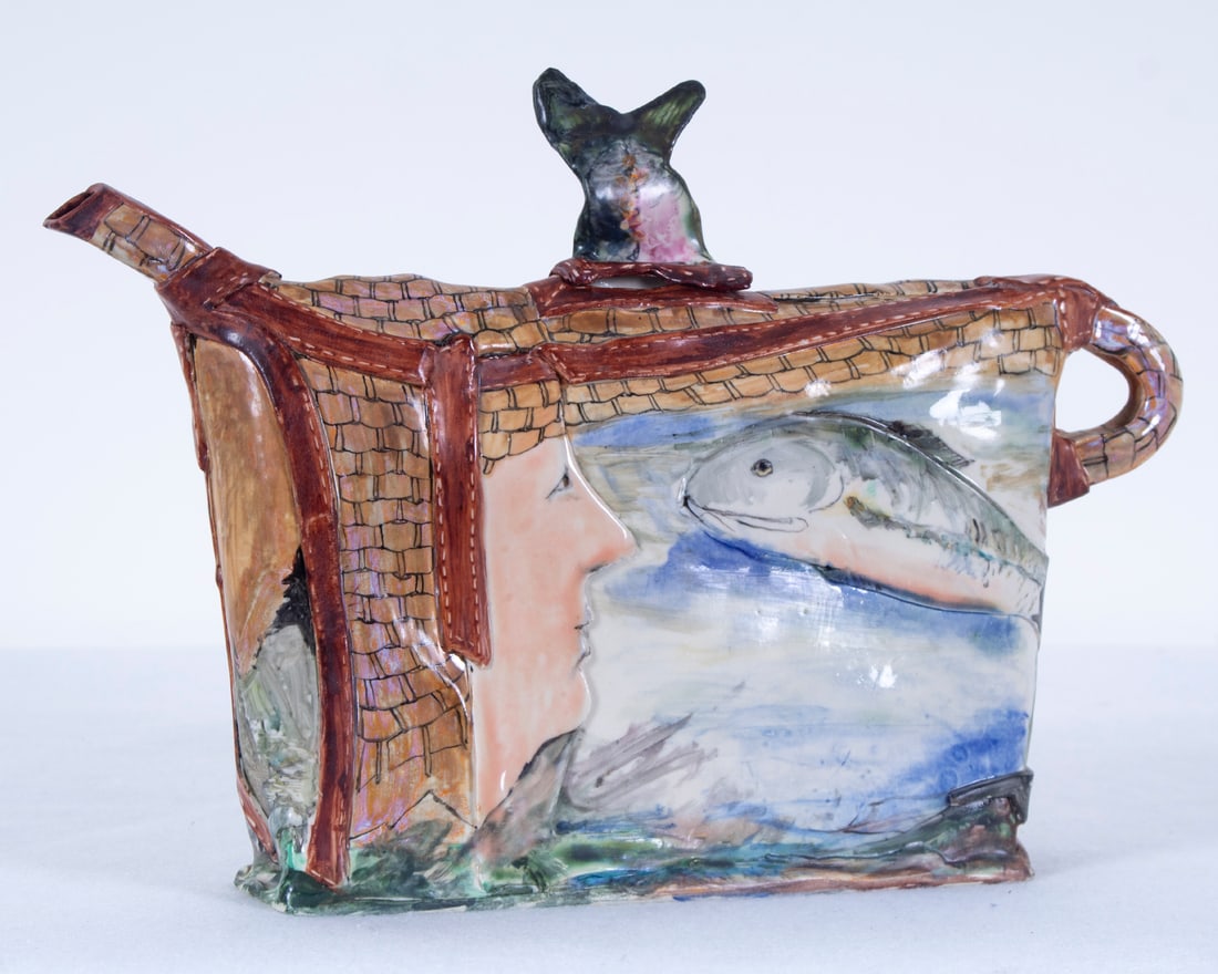 Gerry Wallace (20 th Century) California: Fishing basket, painted and glazed porcelain teapot, signed underneath, 9 ¼” tall, 13” wide. Acquired from/ Provenance: Del Mano Gallery, June 1996.