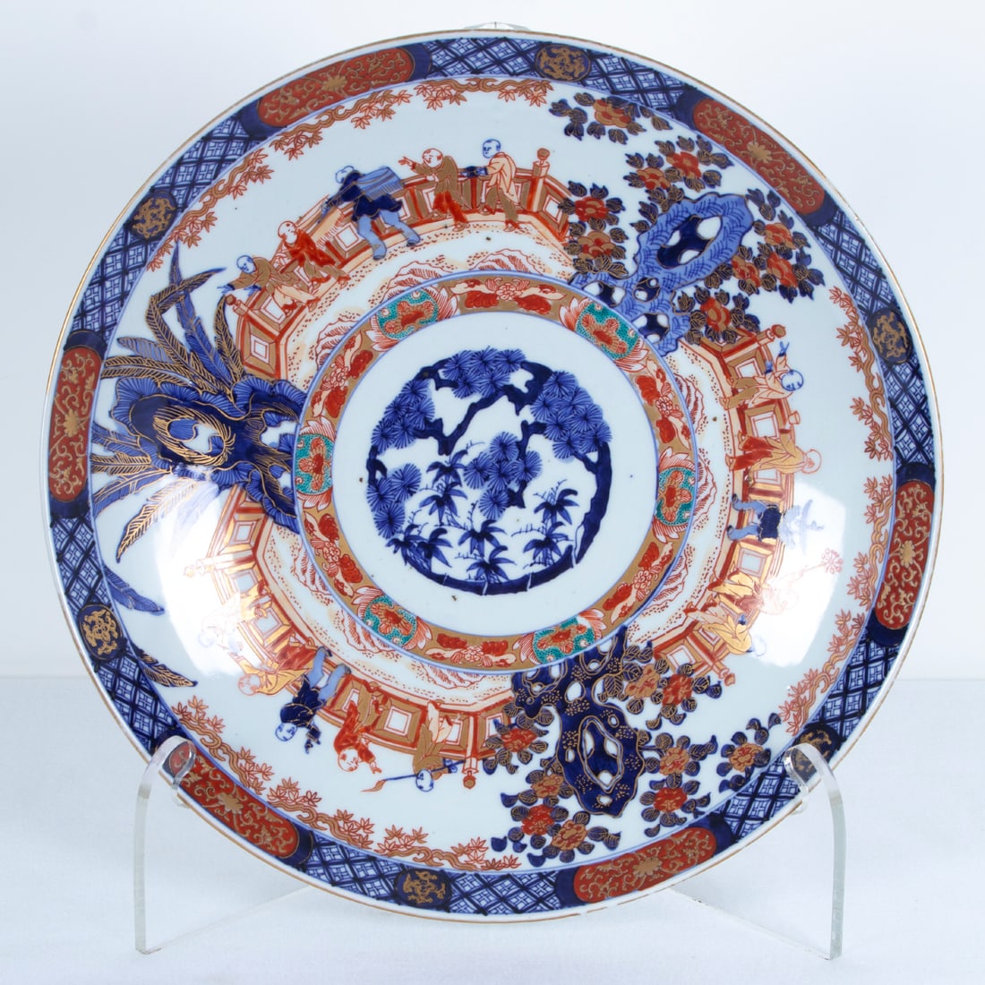 Japanese Imari Porcelain (19 th Century): Monumental charger, painted and glazed porcelain, 18” diameter, 3” deep. Provenance: Connoisseur Antiques. Los Angeles From an important Beverly Hills private collection.