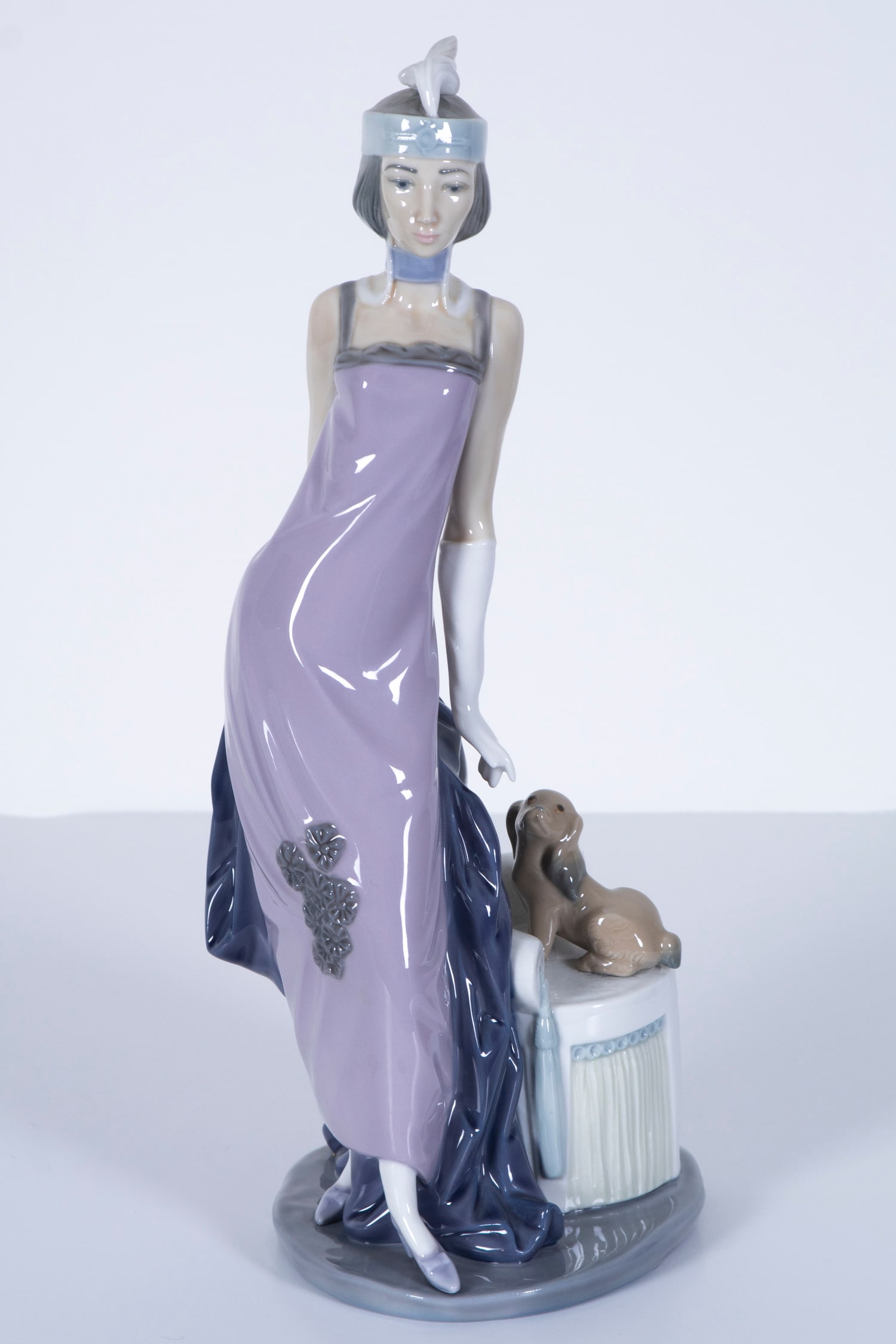 Lladro porcelain: COUPLET LADY, #5174, flapper girl with dog by her side, painted and glazed porcelain figurine, hallmarked underneath, 13 ½”.