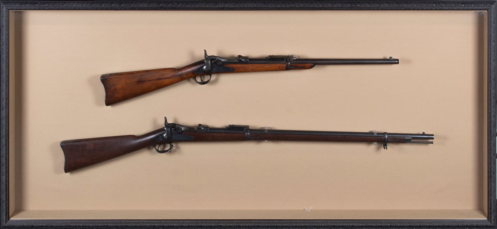 Pair of antique Springfield rifles: Trapdoor single shot breechloading percussion cap military rifle, length 52”, together with a Sporterized Trapdoor rifle, length 41 ½”, both stamped “U.S. Model 1884” and ��