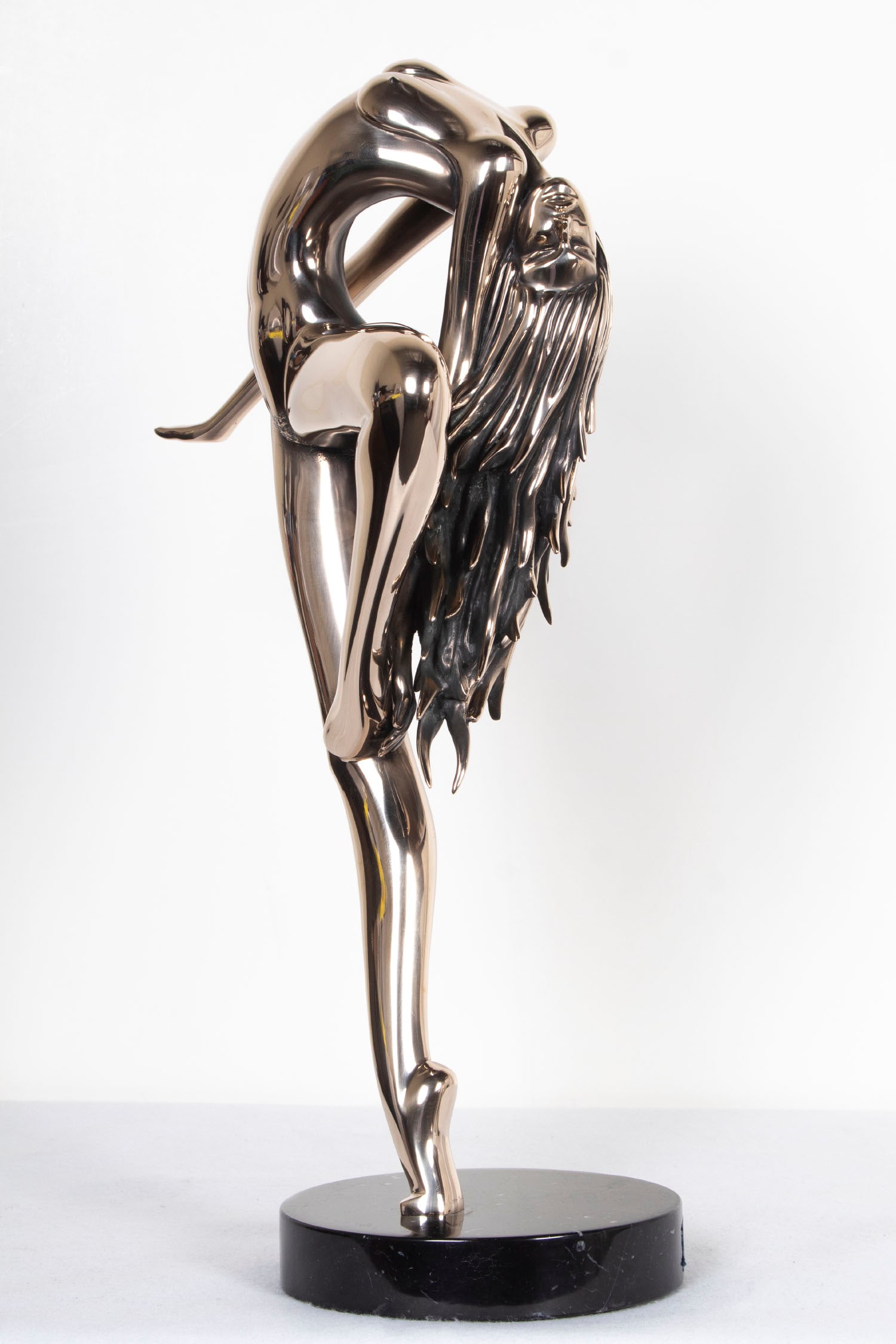 Tom Bennett (1928-) California: SUNDANCER, 1982, cast bronze sculpture with high polish, signed and dated and numbered 58/150, overall 24 ½ x 15 x 9” including marble base. Provenance: Artist’s signed certificate.