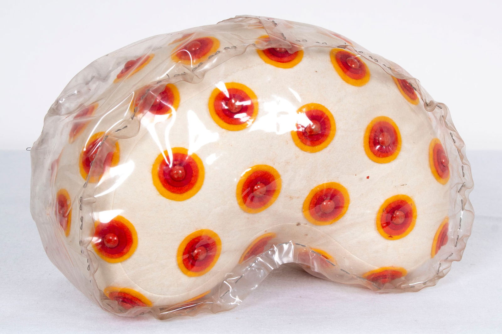 Edie Ellis Brown (b. 1937) American: PILLOW, felt pillow with cut-out felt circles and painted buttons, a signature not found, later covered in a stapled plastic case by the artist at the request of the recipient to protect the fabric, o