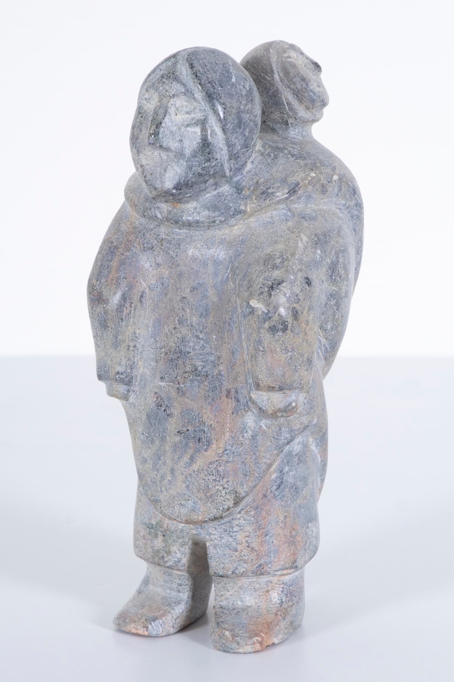 Inuit Art: Quatalik: STANDING WOMAN WITH CHILD, 1970’s, carved steatite figurine, signed underneath, 9 x 4 x 3 ¾”. Provenance: From the collection of Museum of Riverside, California.
