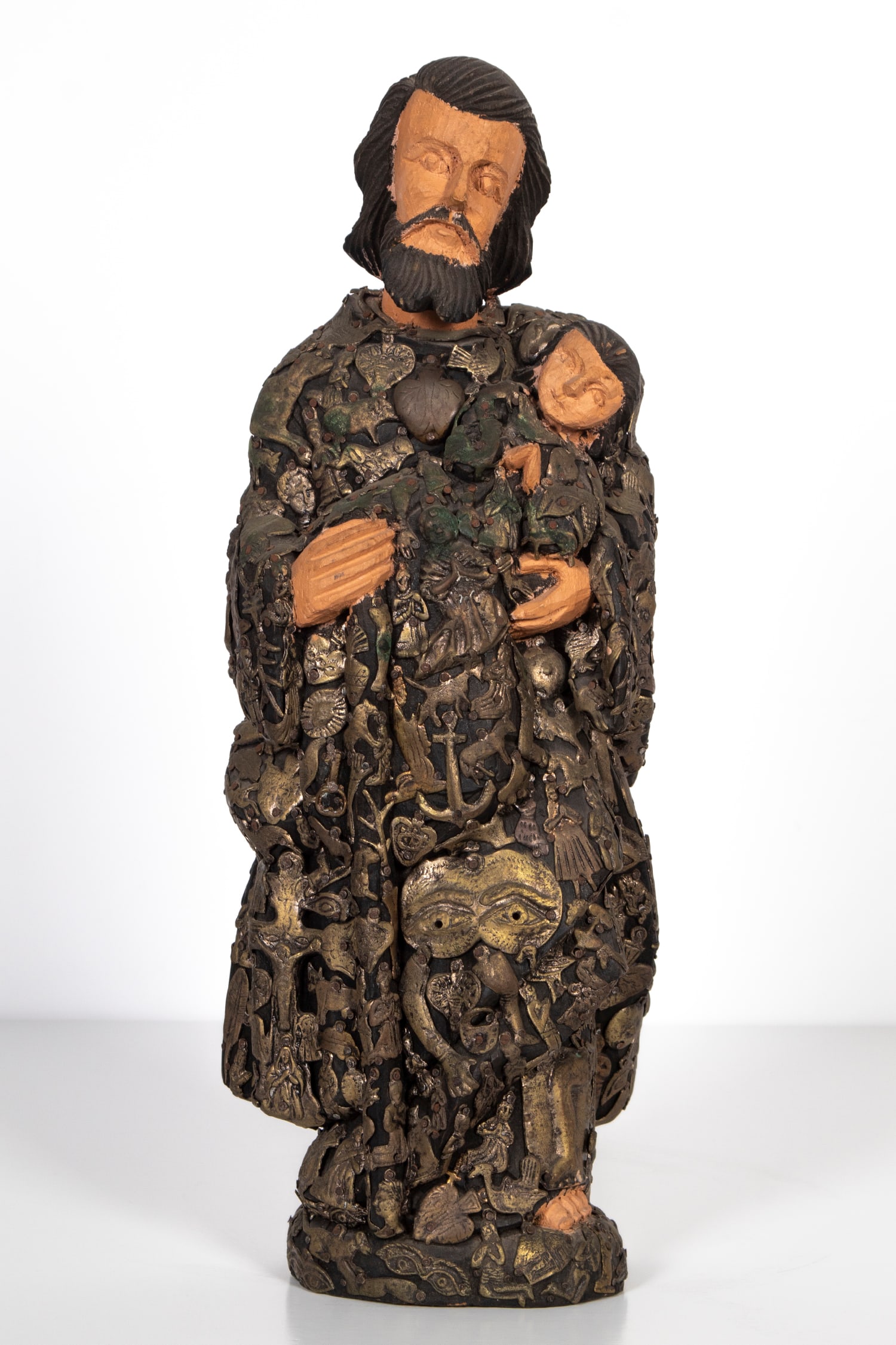 Mexican Folk Art: Milagros Santos, carved and painted wood Santos figure covered with dozens of Milagros (religious folk art charms), 16 ¼” tall. From the Collection of Urban S. Hirsch III.