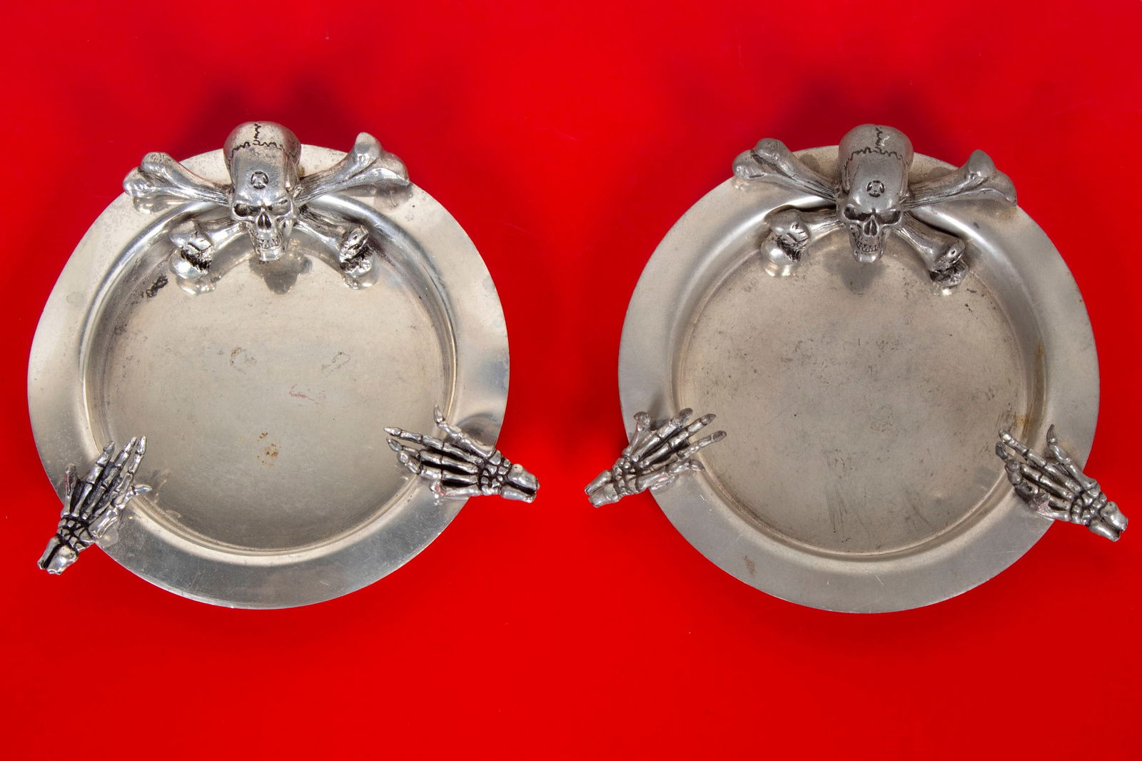Alchemy pewter skull ashtrays (two): A pair of Sheffield England ashtrays, hallmarked underneath, 5” at widest point. From the Collection of Urban S. Hirsch III. (2)