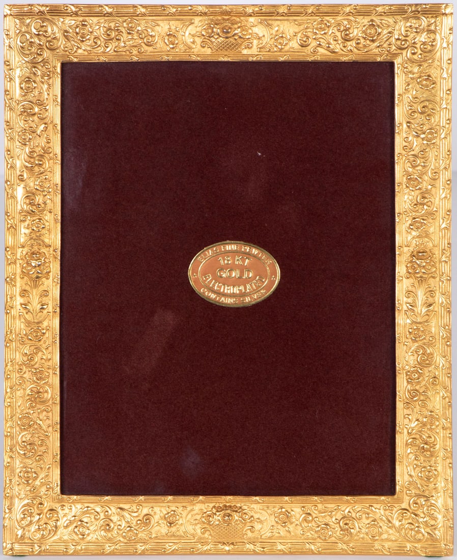 Elias Fine Pewter: 18kt Gold Frame: Pewter and silver frame with 18 kt gold-plate with ornate design and felt back, label on interior, 10 ½ x 8 ½”.