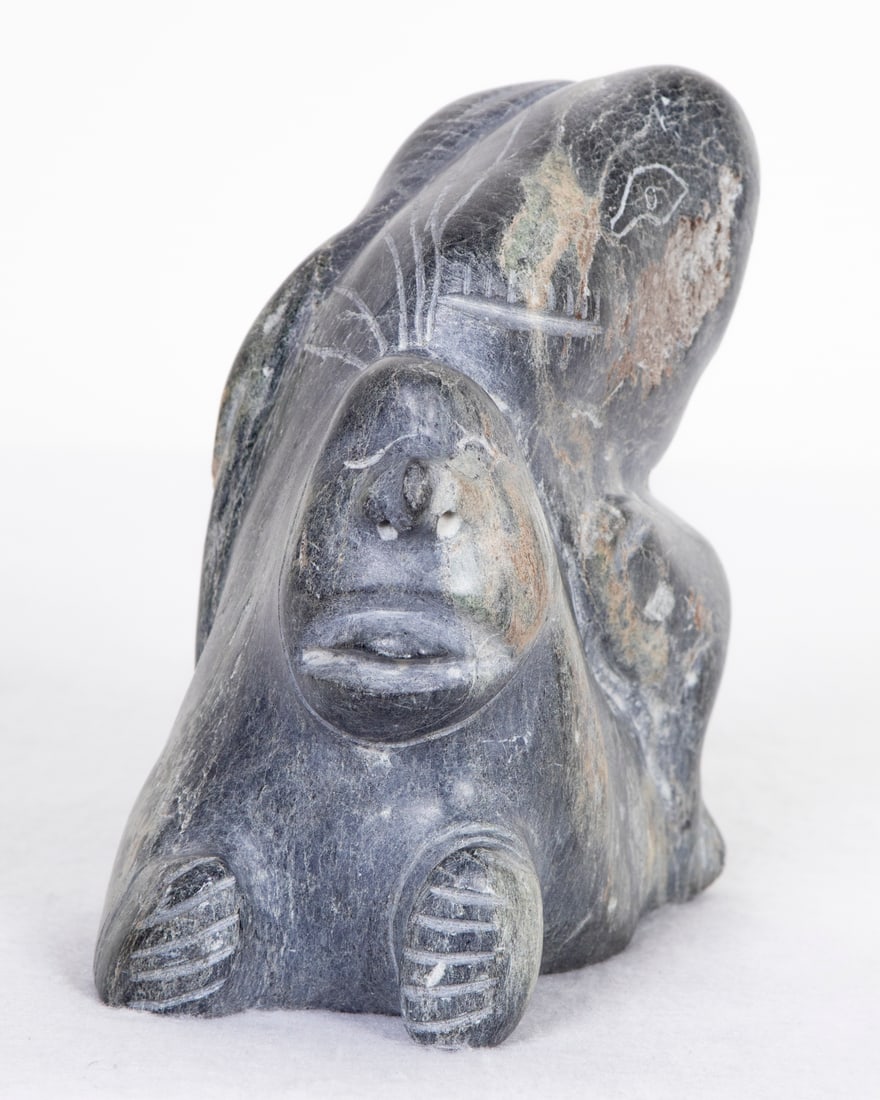 Inuit Art: Igutsia Pelly Bay Canada Artist: SPIRITS, 1975, carved steatite statue, signed and dated underneath and with label, 6 ¼ x 3 ½ x 6 ¼”, weight less than 10 lbs. Provenance: From the collection of Museum of Ri