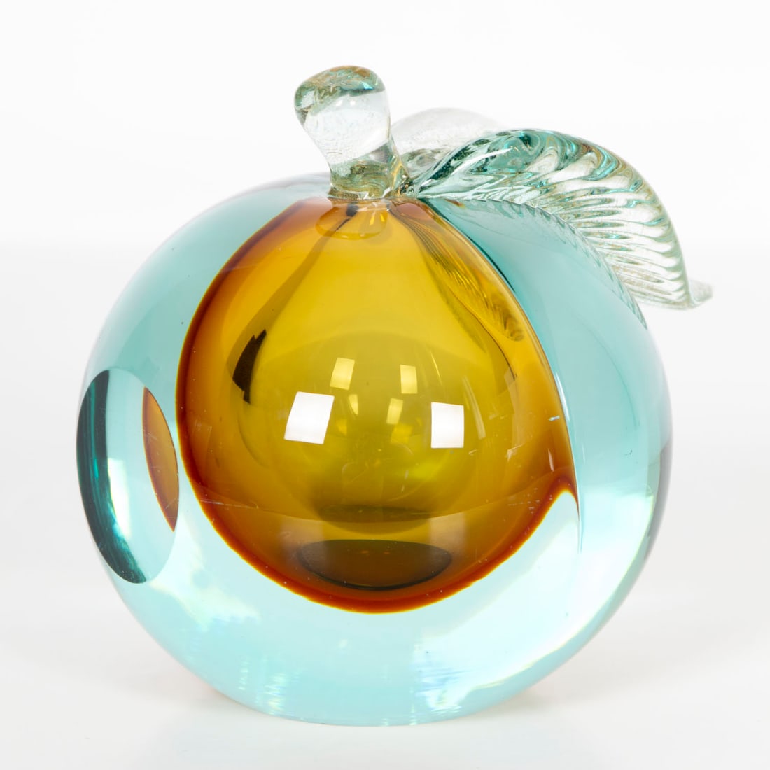 attributed to Livio Seguso art glass (Murano): AQUA AND AMBER FRUIT, double walled color and clear round glass, leaf infused with gold dust, 5: tall, 4 ½” diameter.