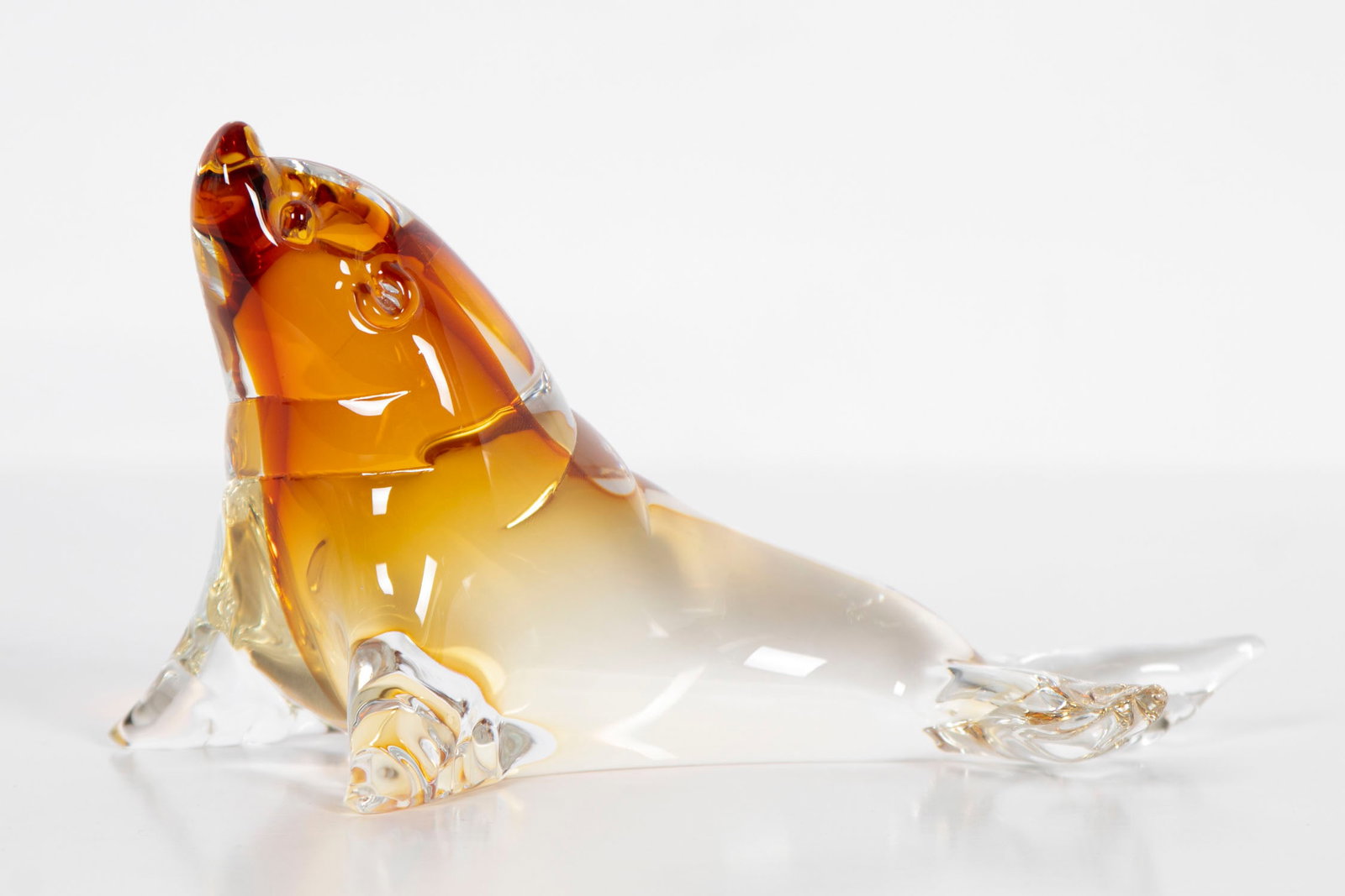 Murano Glass or style of: SEAL, clear and amber glass figurine, signed underneath, 4 x 3 ½ x 5 ½”.