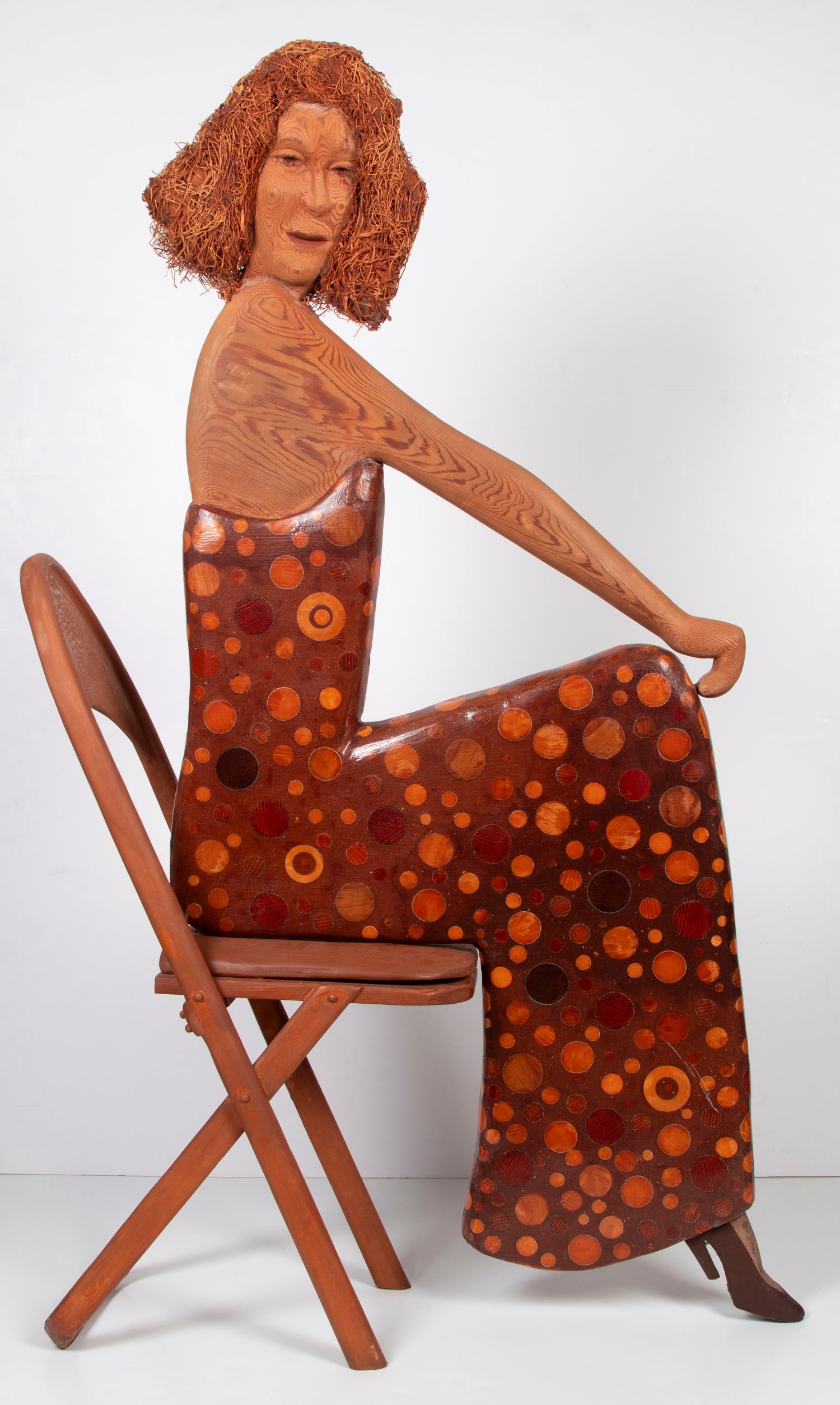 Barbara Spring (1916-2011) British: SEATED WOMAN carved and painted wood sculpture with wood-straw hair, a signature not found, overall 54 x 30 x 12”, woman bolts onto chair. From a private Burbank corporate collection, paid $5300