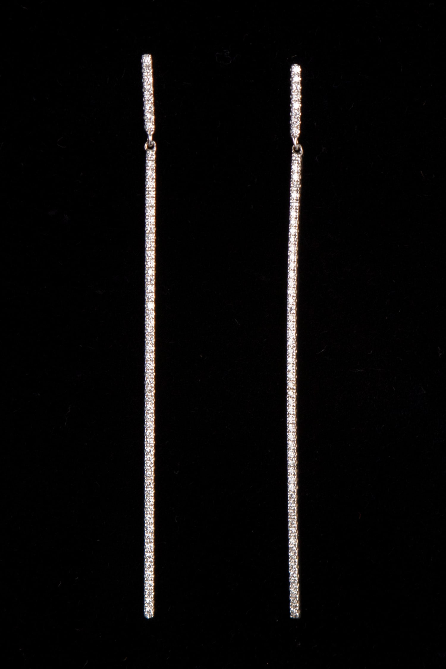 Jewelry: 18k White Gold and Diamond Earrings: 18k white gold earrings with bead-set diamonds, VS-1, color F, stamped, surrounded by 6 bead-set diamonds, each VS-1, color G, 70 mm length, weighs 2.3 grams. Note: there are no earring backings. Disp