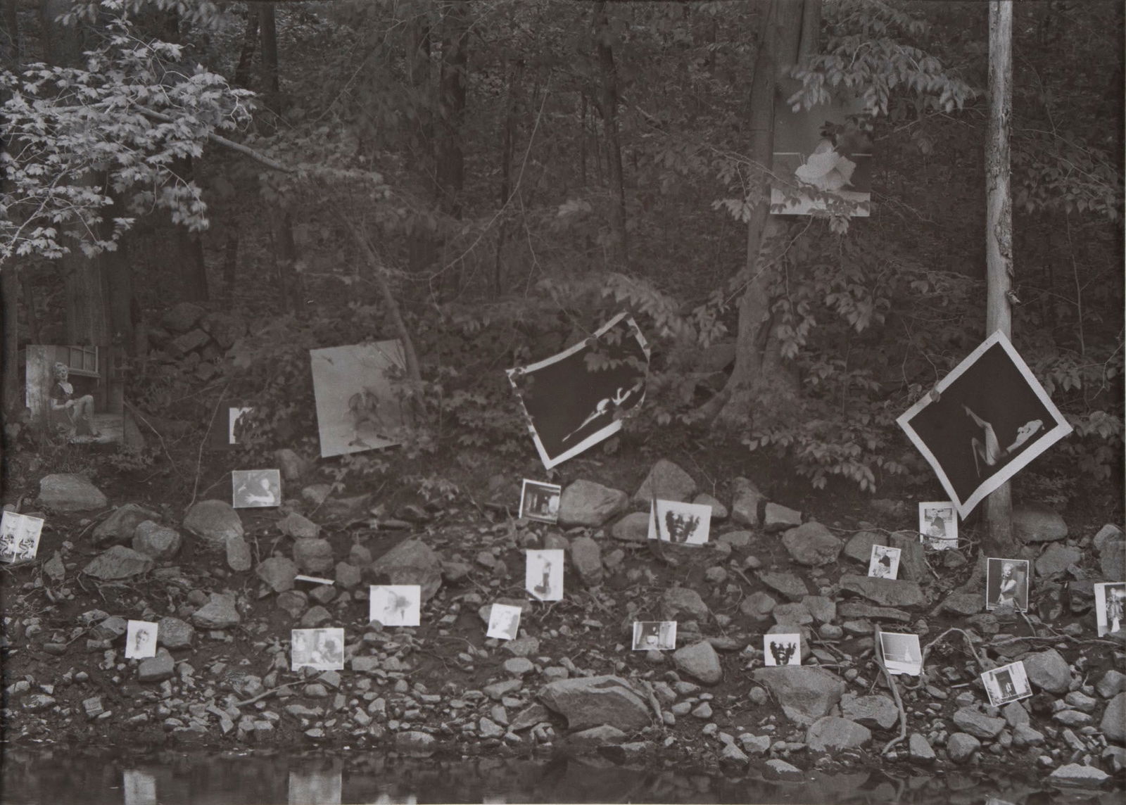Milton Greene (1922-1985) New York Los Angeles: UNTITLED (Marilyn Monroe photographs displayed along a riverbank), 1974, gelatin silver print, signed and dated on the verso, sheet 11 x 14”, mat 14 x 20”. Provenance: from the collection