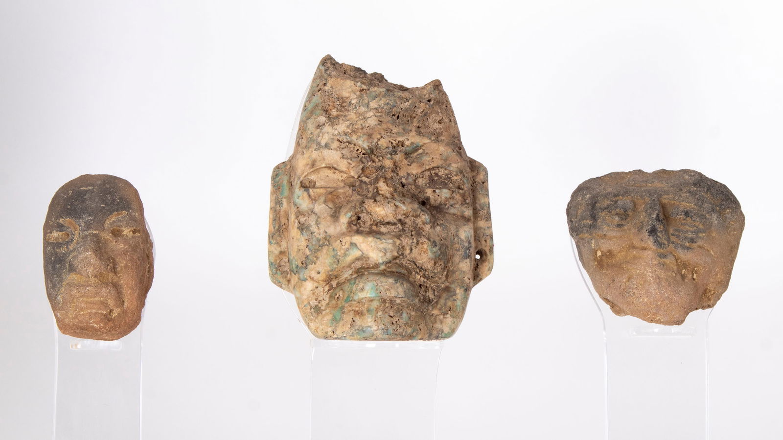 Pre-Columbian Pottery: Three ceramic fragments mounted on Lucite stand, fragments 2”, 3 ½” & 1 ¾” tall, stand 11 x 3 ¾ x 7”.