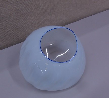Dale Chihuly (b. 1941) American: UNTITLED, 1995, milk-white hand blown glass with blue rim, signed and dated underneath, 10” diameter, in good studio condition.