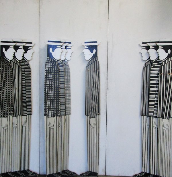 Yannis Gaitis (1923-1984) Greek: UNTITLED STANDING MEN, ten cut and painted wood figures attached to three wood panels, overall 82 ¾ x 82 ¾ x 6 ½”, with a circular Greek stamped on the verso of one figure partially reads : “YA