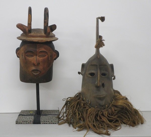 African Art (three): Carved two-face wood mask with stand, 27 ½” tall including stand, some losses; A carved wood mask with hair collar, 31”; Together with a Bobo Fing tribe hair collar, all in good to generally good