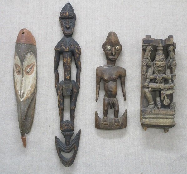 Oceanic Art (four): Carved and painted wood mask with seashell eyes, 29 ½” tall; A carved figure of man with loin-cloth, 40 ½” tall; A carved wood man with stone eyes, 23 ½” tall; Together with an Indonesian woo