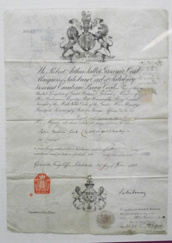 Antique Document & John Cheever autograph (two): British travel visa issued by the London Foreign Office to Sophie Beatrice Cook in 1892, with various destination stamps, 15 x 11”, with folds for pocket travel, otherwise in good aged condition; To