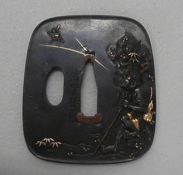 Japanese Sword Tsuba: Bronze sword guard with gold highlight and inscription, 2 ½ x 2 ¼ x 1/8”, old tape residue on verso, in good aged condition. Provenance: Sotheby’s sale #5725, lot 734.