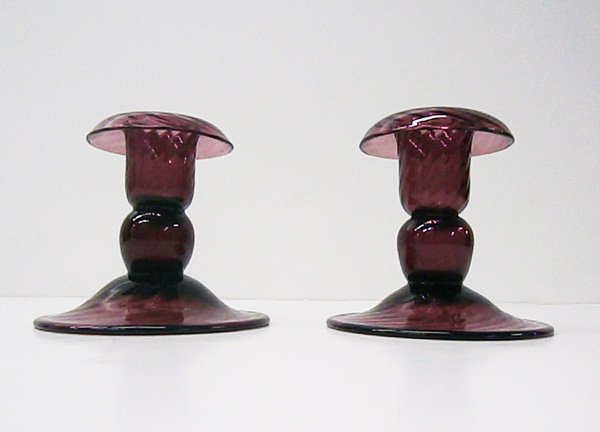 Steuben glass: A pair of purple glass candlesticks, both hallmarked, 3 ½” tall, 4” diameter, both in good condition.